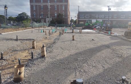 praiano-home-improvements-new-construction-bayshore-village-1 gravel pad with plumbing risers and sleeves ahead of concrete placement.