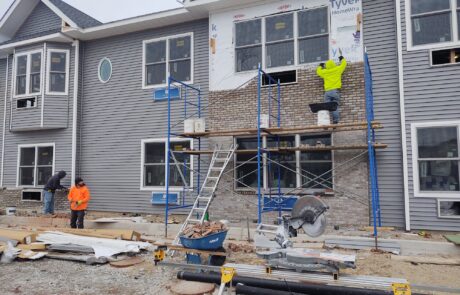praiano-home-improvements-new-construction-bayshore-village-10 window installation with masonry veneer and siding underway