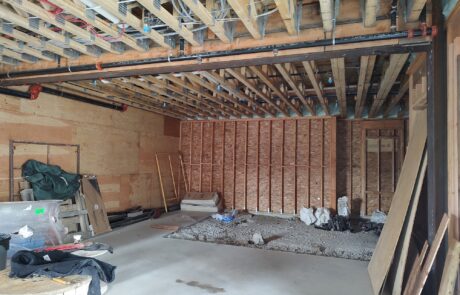 praiano-home-improvements-new-construction-bayshore-village-13 exposed framing with plumbing and mechanical runs above slab