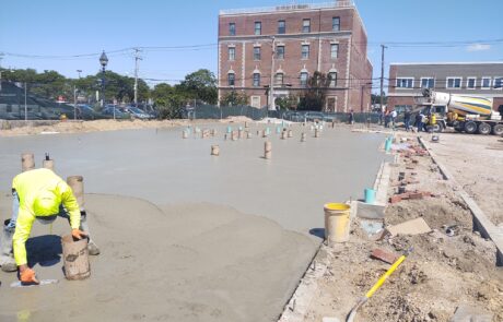 praiano-home-improvements-new-construction-bayshore-village-2 fresh concrete slab being poured and finished for multi-unit building.